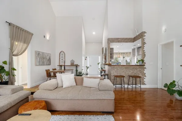 a living room with furniture and wooden floor