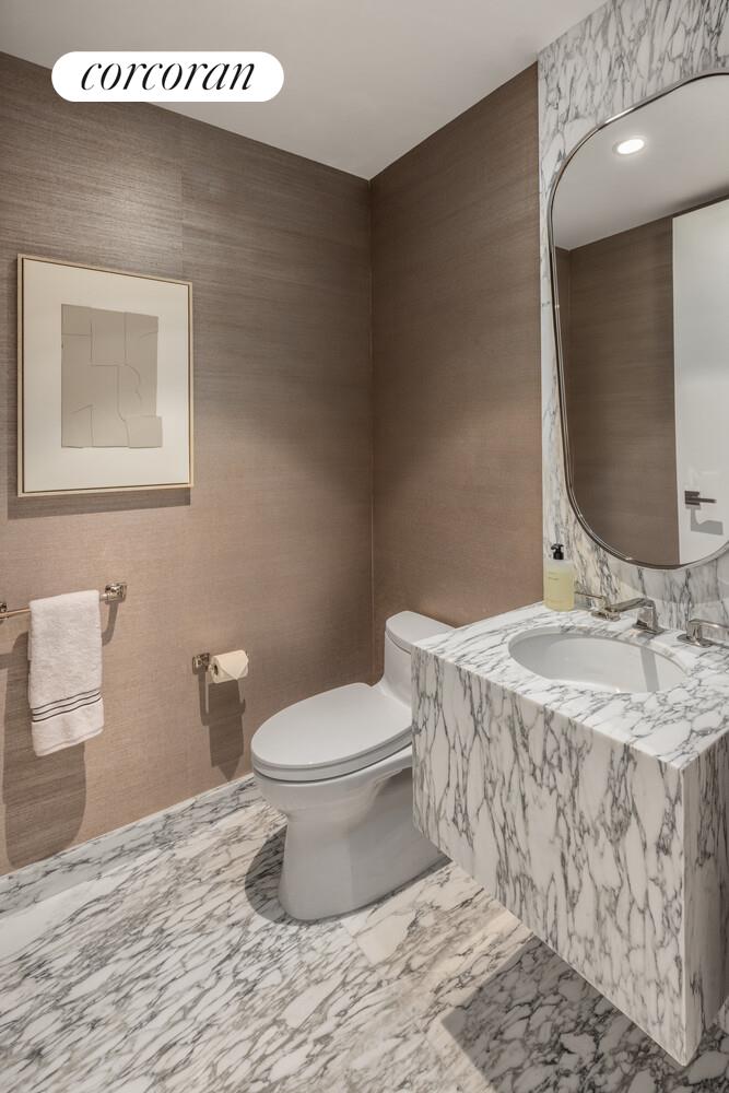 50 West 66th Street, Unit 8B Manhattan, NY 10023 - Photo 11 of 43 a bathroom with a toilet sink and mirror