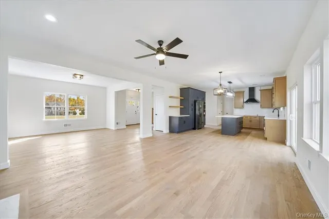 a view of a kitchen with a sink and a refrigerator