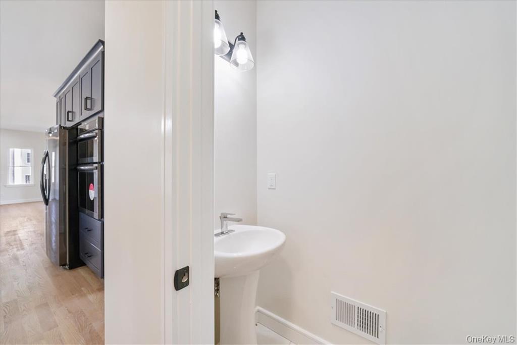 Lot 13-27 Sawyer Way Wallkill, NY 12589 - Photo 12 of 35 a bathroom with a sink and mirror