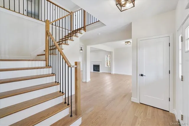 a view of entryway and hall with wooden floor
