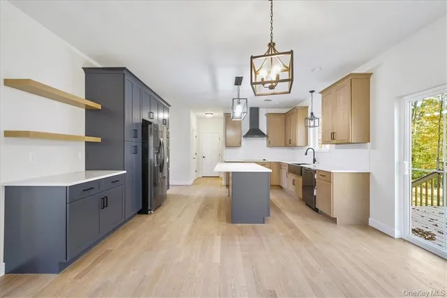 a large kitchen with a lot of cabinets and stainless steel appliances