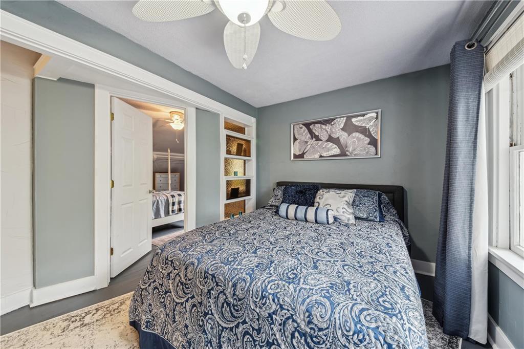 122 Klir Road Pittsburgh, PA 15209 - Photo 18 of 31 a bedroom with a large bed and a chandelier