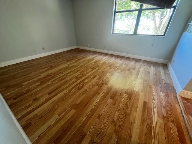 2255 Lindell Boulevard, Unit 4209 Delray Beach, FL 33444 - Photo 9 of 15 a view of an empty room and wooden floor