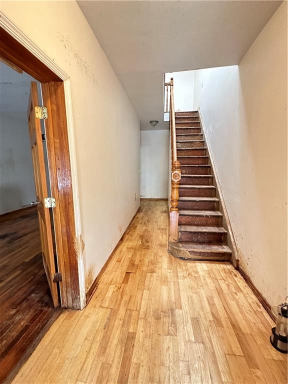 868 55th Street Brooklyn, NY 11220 - Photo 8 of 9 a view of a hallway with wooden floor and stairs
