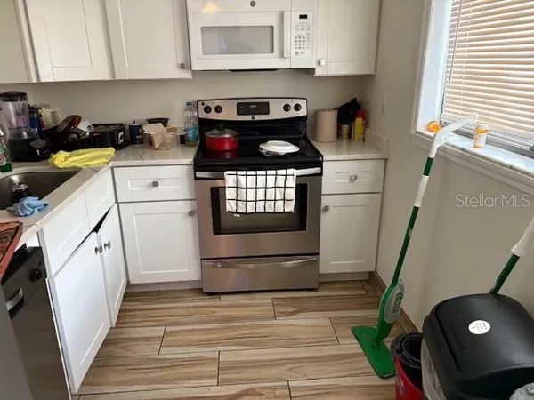 a kitchen with a sink a stove and cabinets