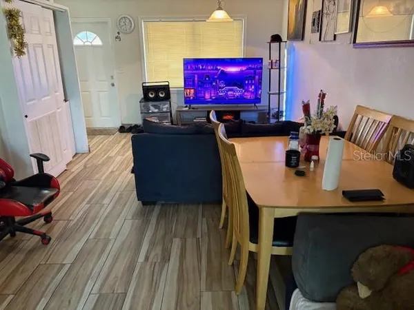a dining room with furniture and wooden floor
