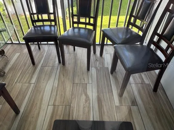 a view of a couches and dining table in a balcony