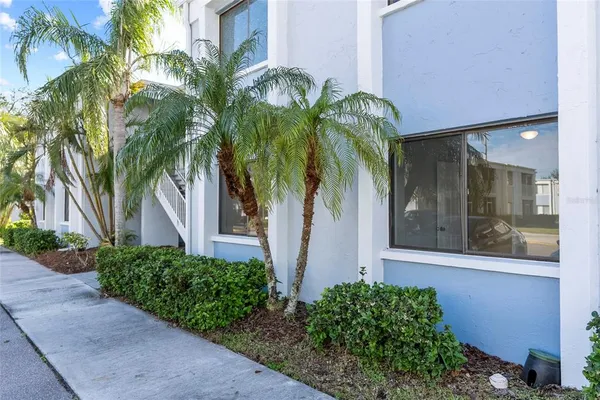 a front view of yellow house with a yard