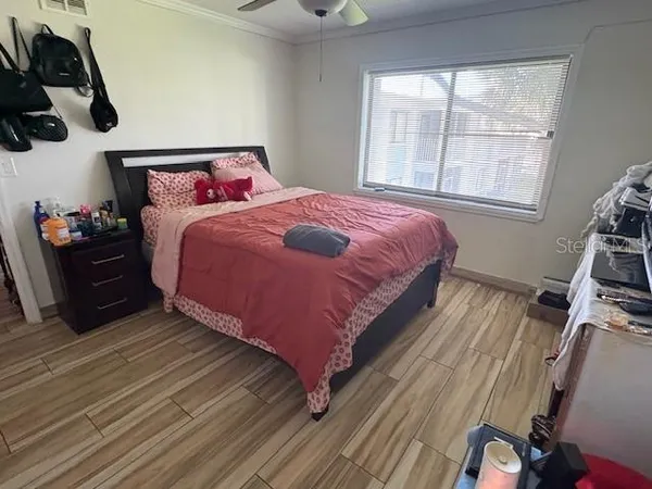 a bedroom with a bed and wooden floor