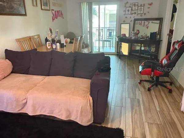 a living room with furniture a flat screen tv and a floor