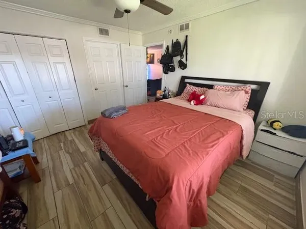 a bedroom with a bed and a mirror