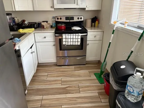 a kitchen with a sink a stove and cabinets