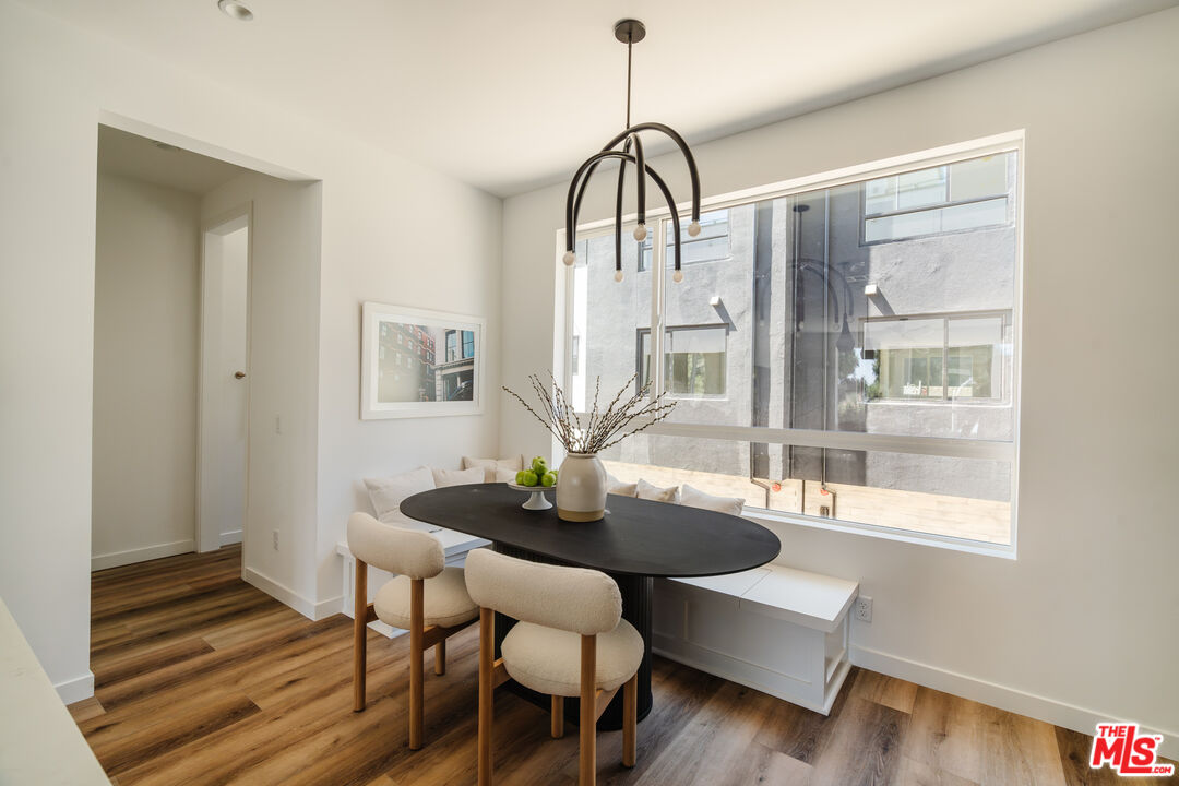 3810 North Riley Lane Los Angeles, CA 90065 - Photo 6 of 29 a dining room with furniture a chandelier and wooden floor