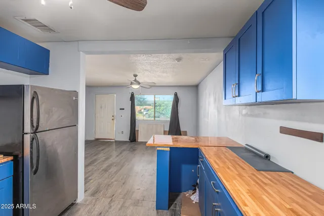 a kitchen with stainless steel appliances granite countertop a refrigerator and a sink