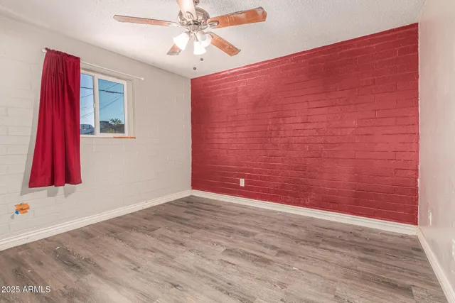 wooden floor in a hall with a large window