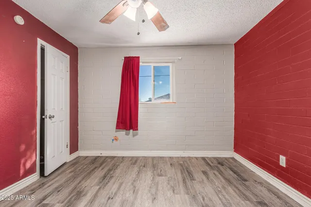 a view of a room with wooden floor and a chandelier
