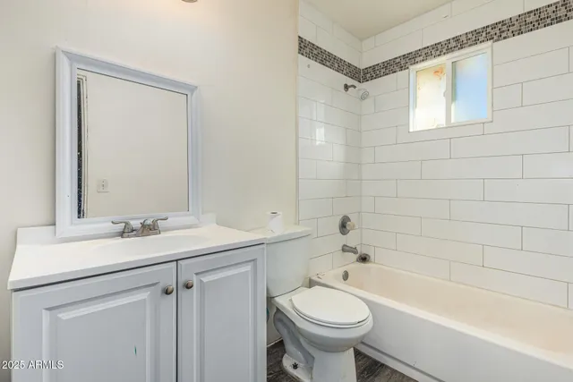a bathroom with a sink a toilet and bathtub