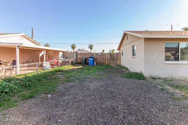 a view of a house with a backyard and porch