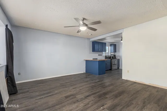a view of kitchen with granite countertop cabinets and wooden floor