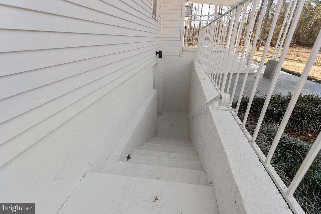 8140 Courthouse Road Spotsylvania, VA 22551 - Photo 37 of 38 a view of staircase with white walls and white door