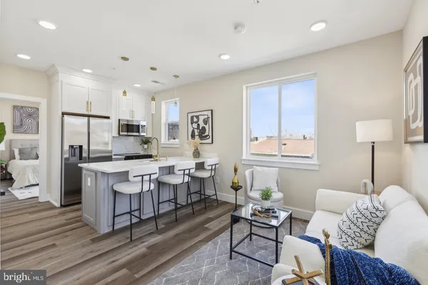 a living room with lots of furniture and kitchen view