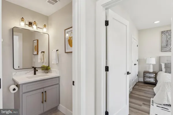 a bathroom with a double vanity sink mirror and