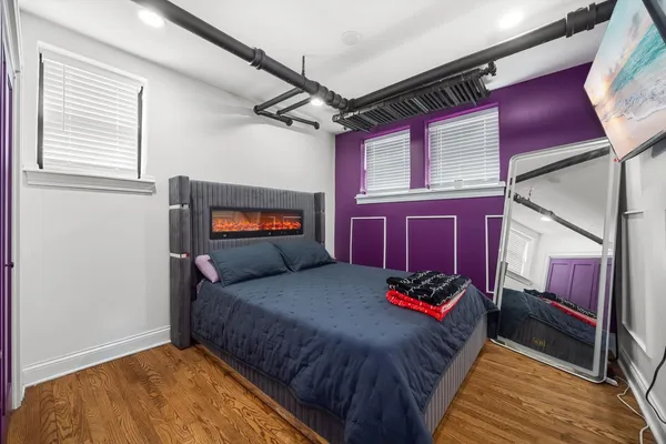 a bedroom with a large bed and a dresser