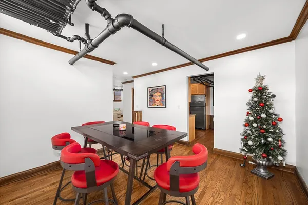 a view of a room with furniture and wooden floor