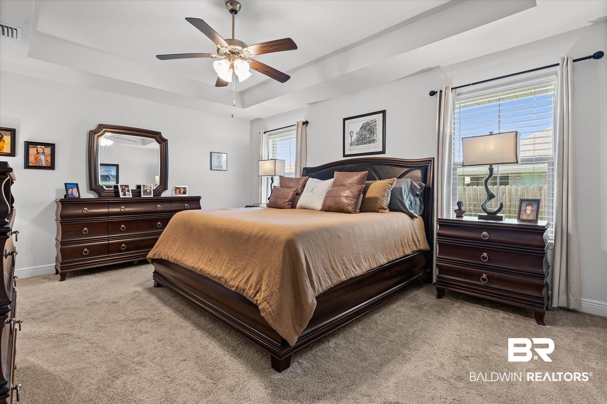 22420 Respite Lane Foley, AL 36535 - Photo 10 of 35 Spacious bedroom featuring tray ceilings, neutral carpeting, and two windows with blinds