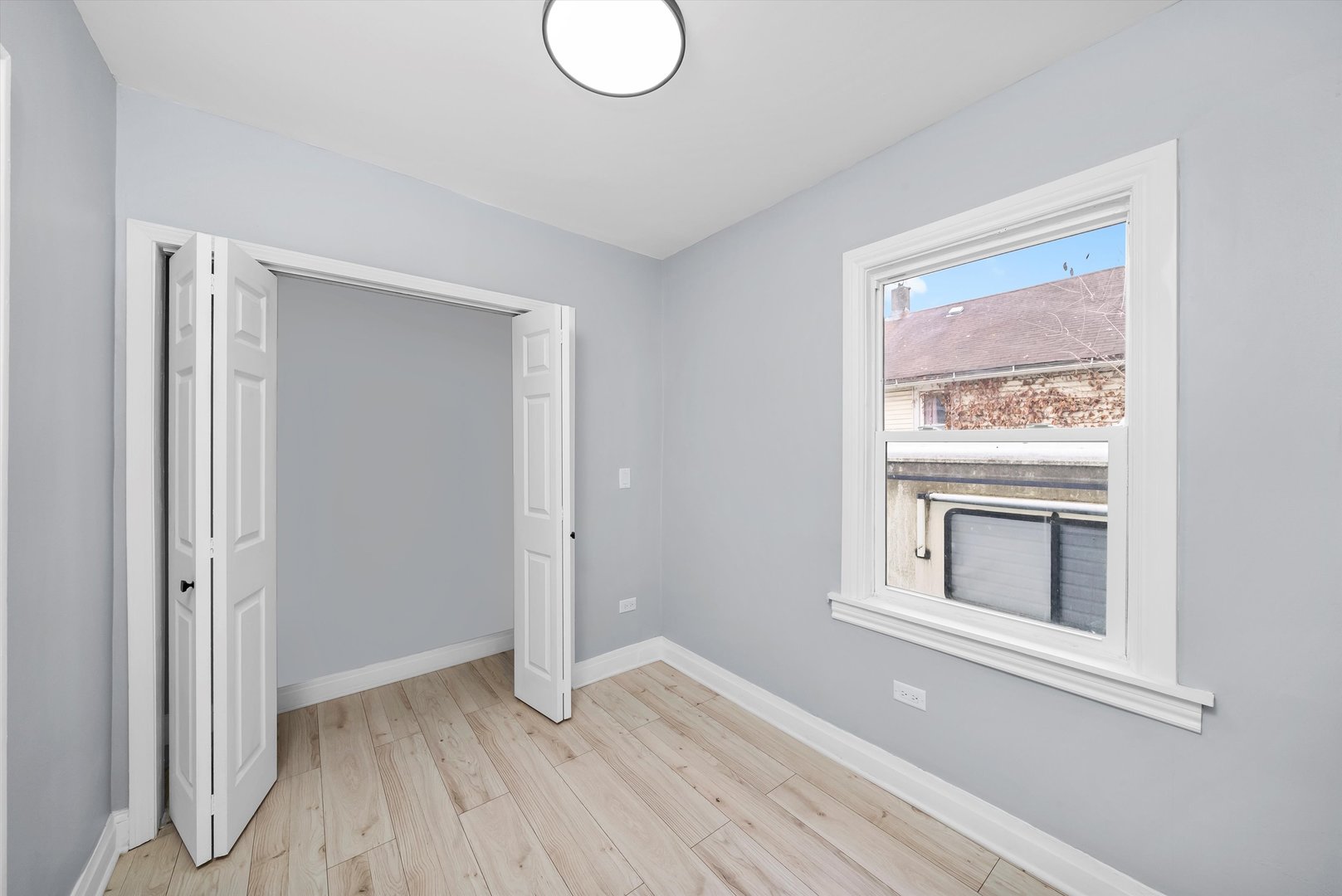 11730 South Perry Avenue Chicago, IL 60628 - Photo 11 of 25 a view of an empty room with wooden floor and a window
