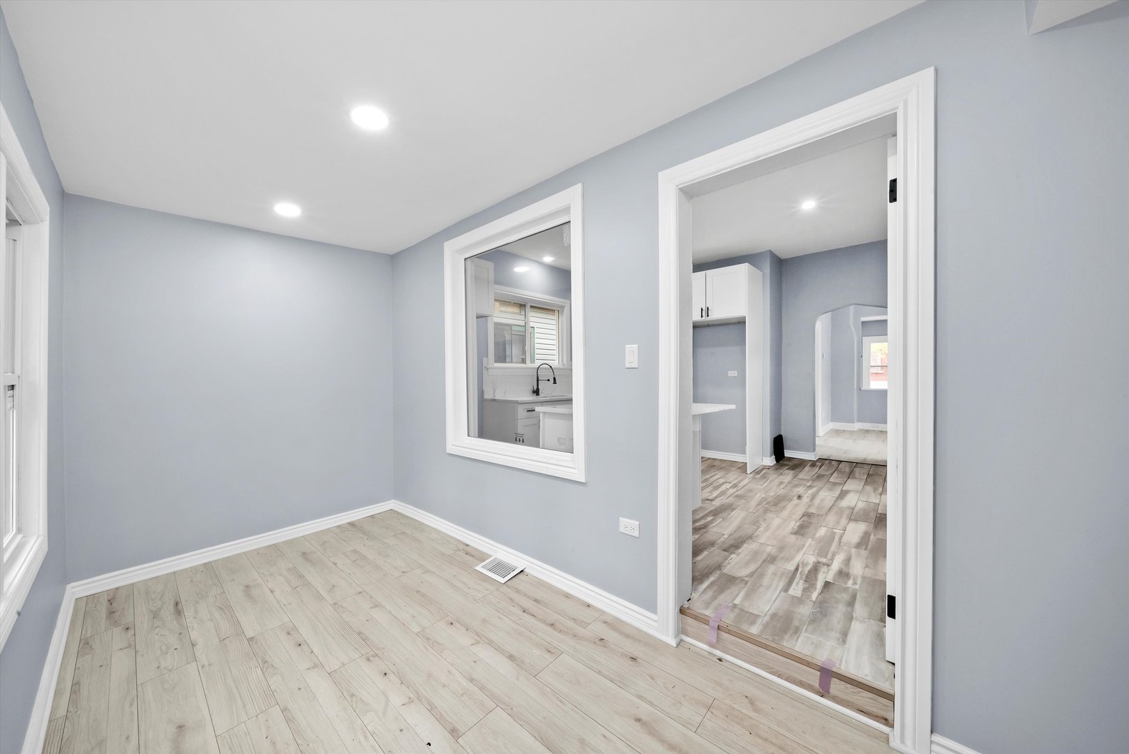 11730 South Perry Avenue Chicago, IL 60628 - Photo 17 of 25 an empty room with wooden floor and windows