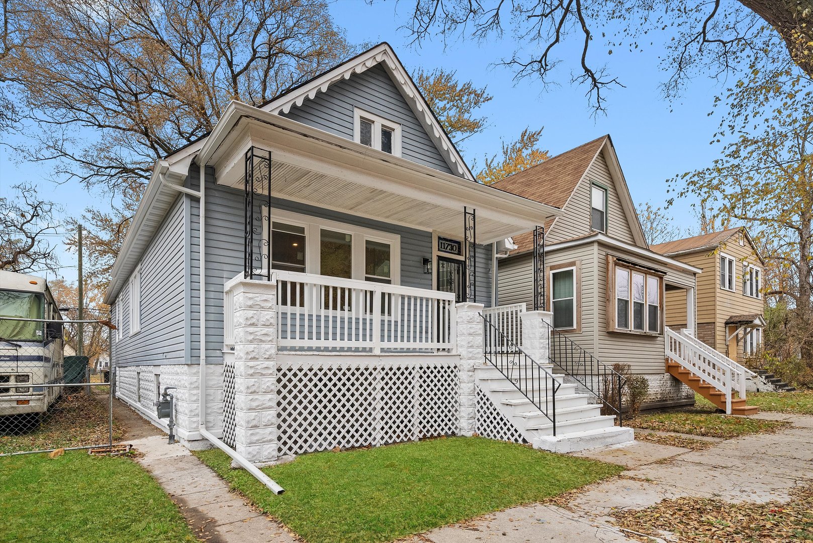 11730 South Perry Avenue Chicago, IL 60628 - Photo 2 of 25 a front view of a house with a garden and trees