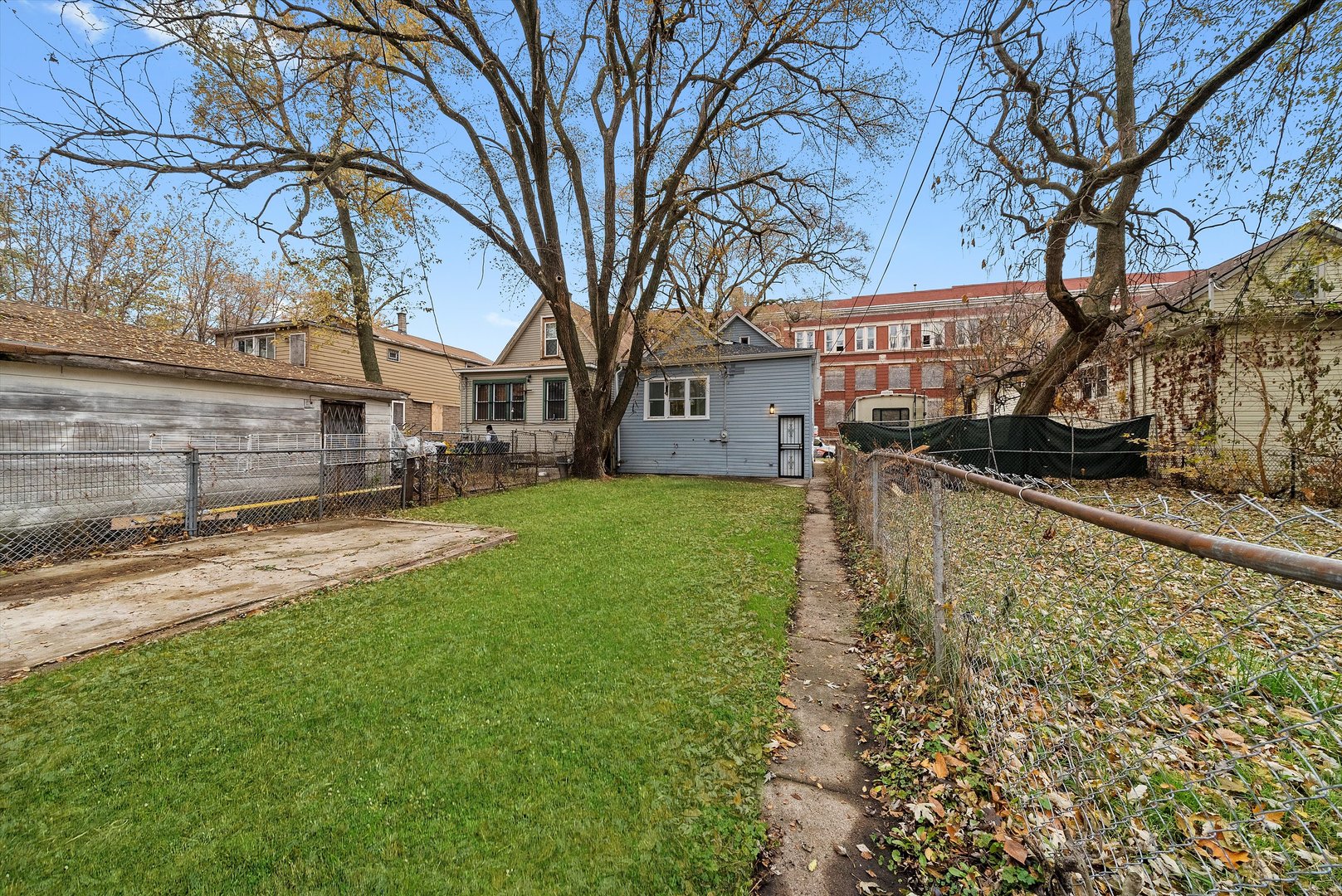 11730 South Perry Avenue Chicago, IL 60628 - Photo 22 of 25 a view of a yard with a large tree