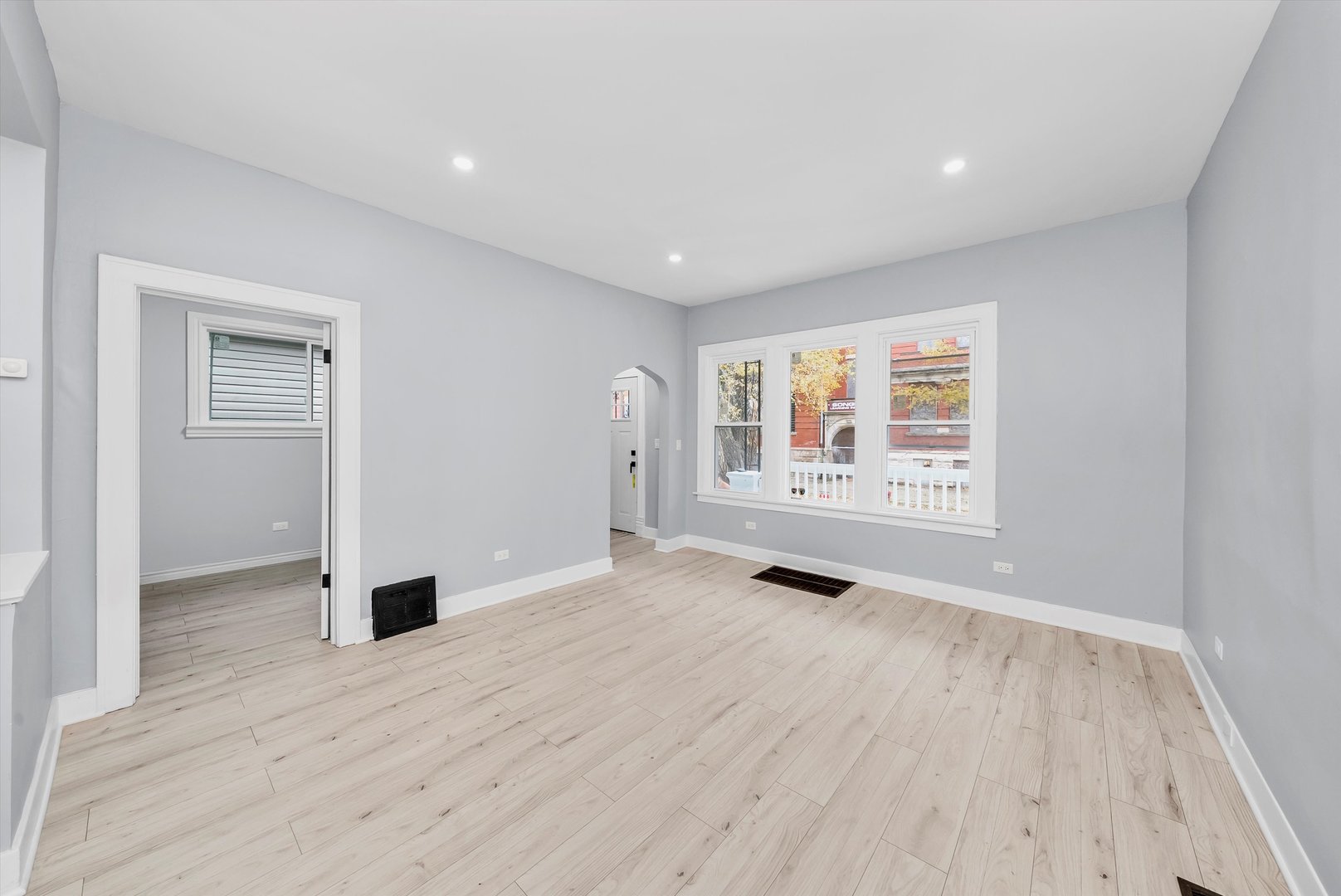 11730 South Perry Avenue Chicago, IL 60628 - Photo 5 of 25 a view of an empty room with wooden floor and a window