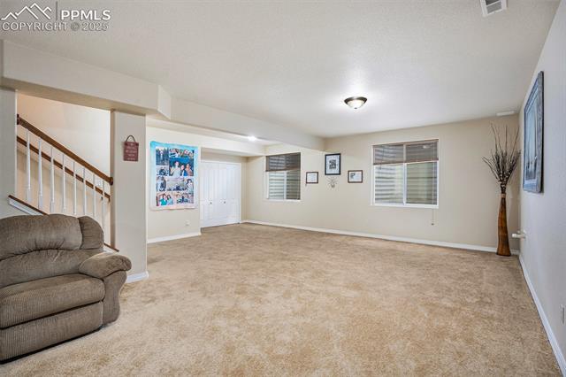 9709 Rockingham Drive Peyton, CO 80831 - Photo 25 of 50 Large basement family room with egress windows and plenty of light!