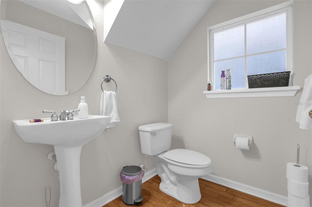 2165 Ridgewood Street Orlando, FL 32803 - Photo 15 of 37 a bathroom with a toilet sink and mirror