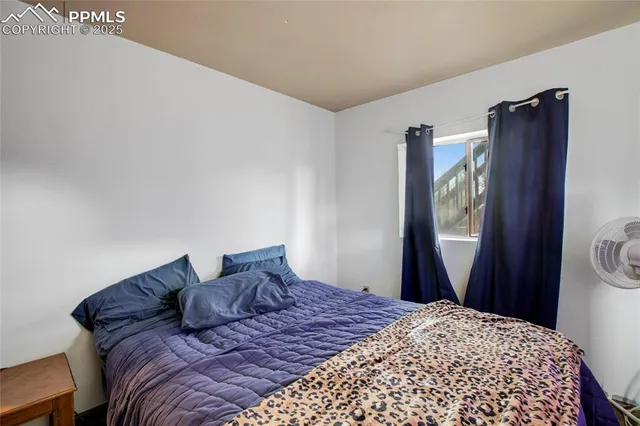 a bedroom with a bed dresser and a window