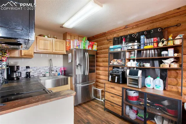 a kitchen with stainless steel appliances granite countertop a refrigerator and a stove