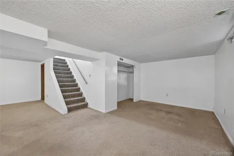 a view of an empty room with stairs