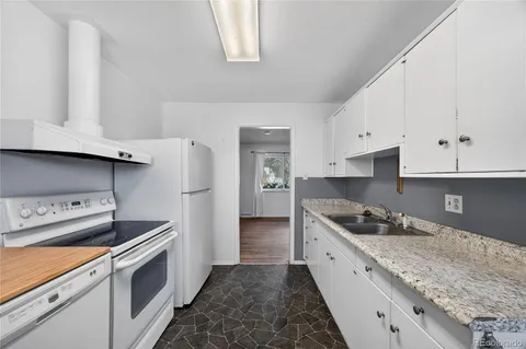 a kitchen with granite countertop cabinets and steel stainless steel appliances