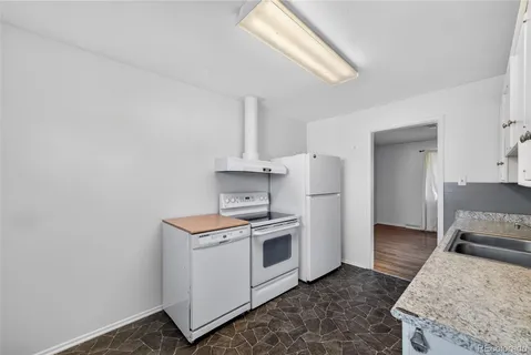 a kitchen with a stove and a refrigerator