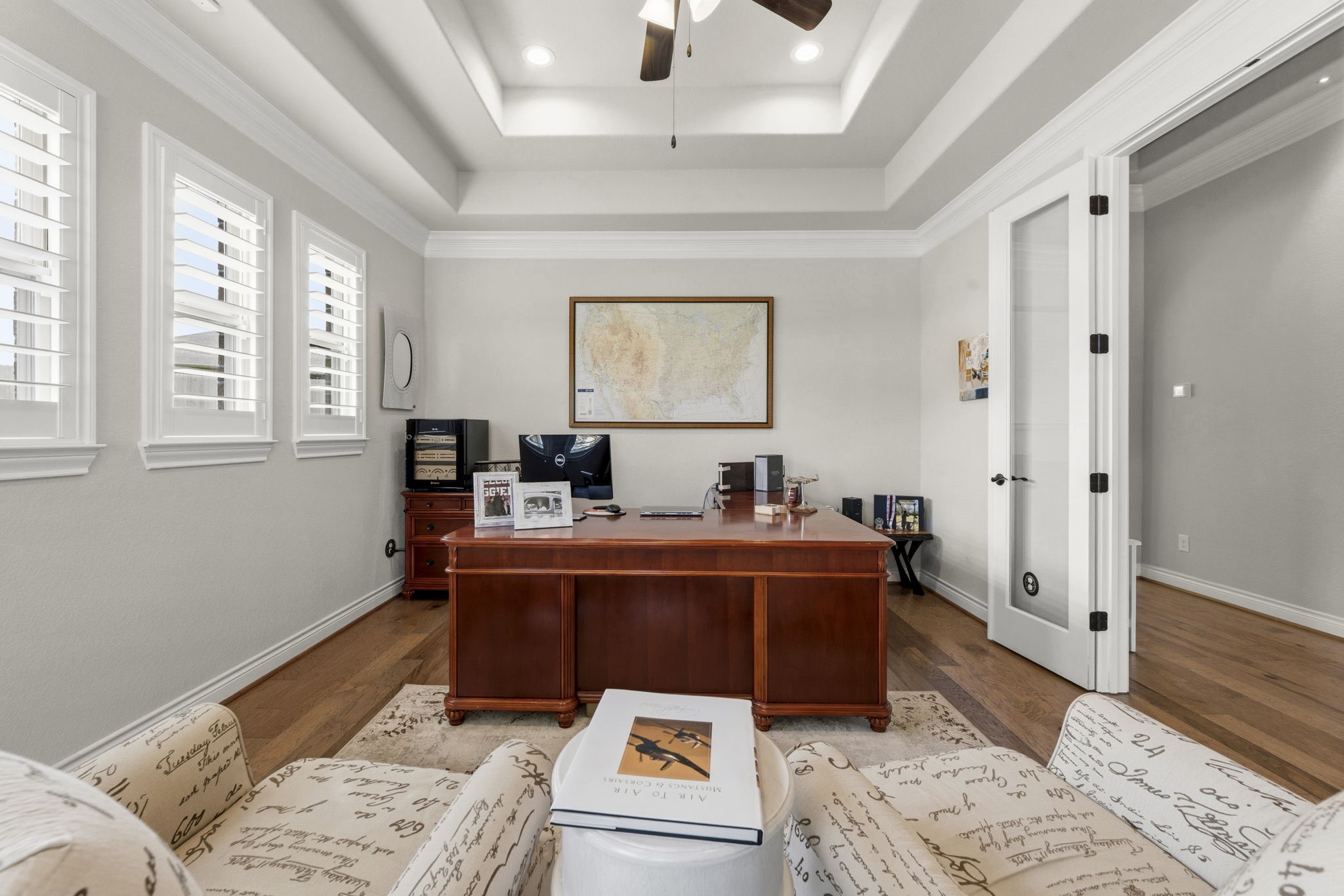 14012 Beartooth Bend Trail Conroe, TX 77384 - Photo 10 of 50 Rich hardwood flooring, an elegant lighted ceiling fan, recessed lighting, and French doors complete the space, offering both style and privacy for working from home or quiet relaxation.