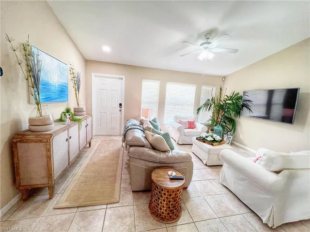 a living room with furniture and flowers