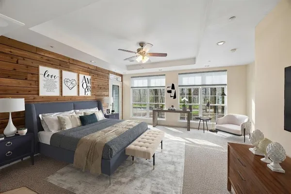 a bedroom with a bed and a large window