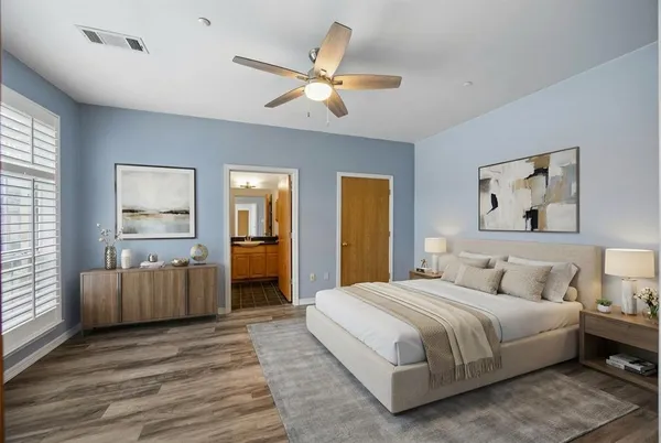 a bedroom with a large bed and a chandelier