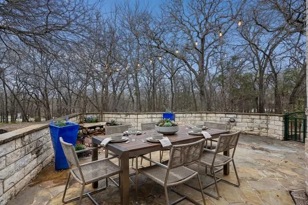 a backyard of a house with table and chairs