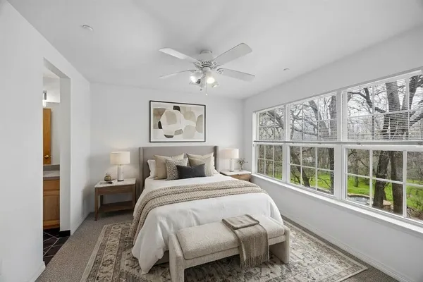 a bedroom with a large bed and a large window