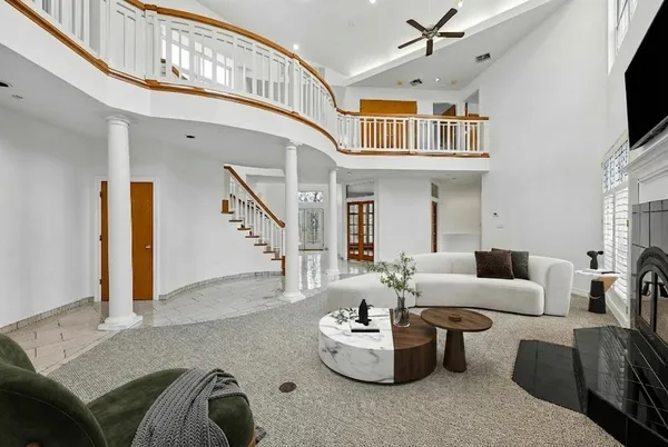 a living room with furniture and a chandelier