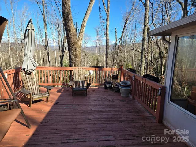 a view of balcony with wooden floor and outdoor seating